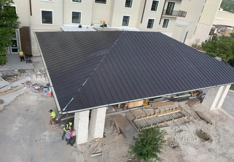 Metal roofing installation team working on a commercial building in Peekskill